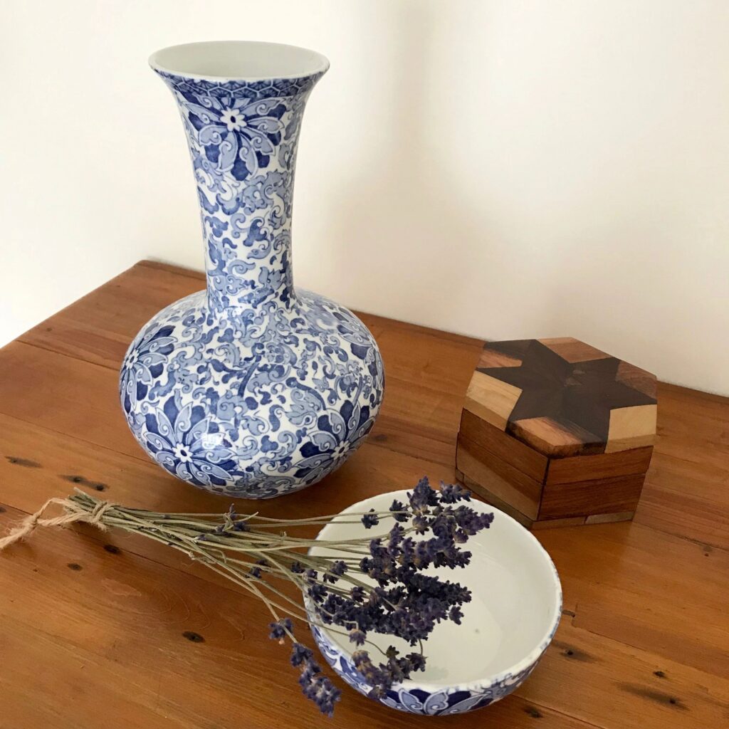A still life with a blue and white porcelain vase and a bunch of lavender