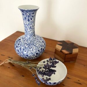 A still life with a blue and white porcelain vase and a bunch of lavender