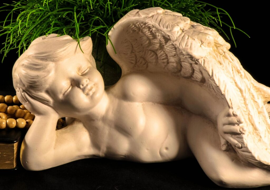 Portrait of sad angel with black background