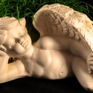 Portrait of sad angel with black background