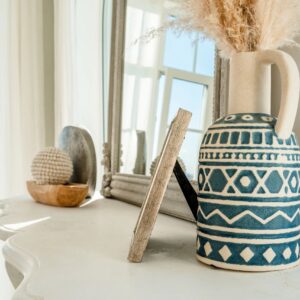 Beautiful cozy interior with vases and figurines, details of the white living room.
