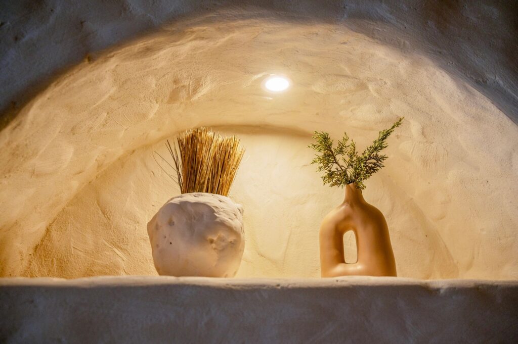 handmade clay pottery in an arch with backlight