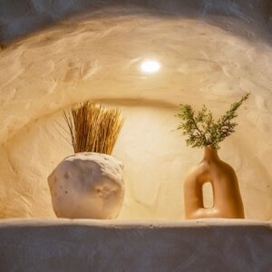 handmade clay pottery in an arch with backlight