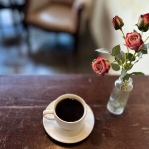 A Quiet Morning Scene: Coffee, Roses, and the Warmth of Wood